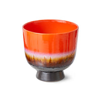 lifestyle image of hand-glazed ceramic flower pot in vibrant red