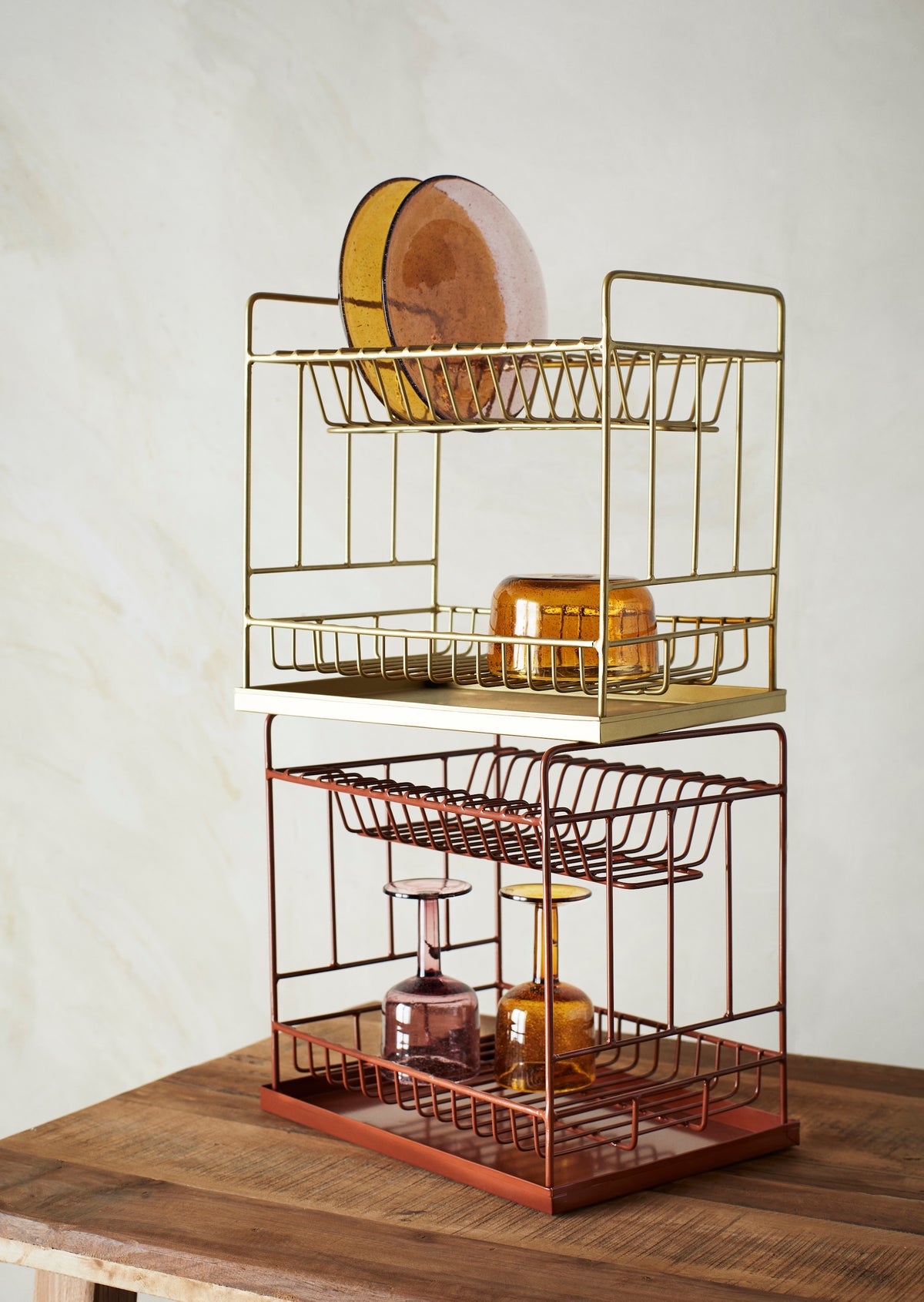 amber bubbled wine glass styled on gold kitchen rack
