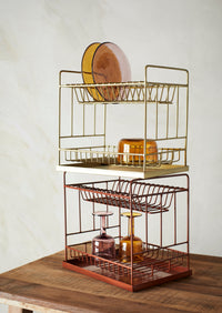 amber bubbled wine glass styled on gold kitchen rack
