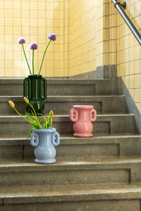 Light blue Amfora vase with flowers alongside other &Klevering vases on concrete steps