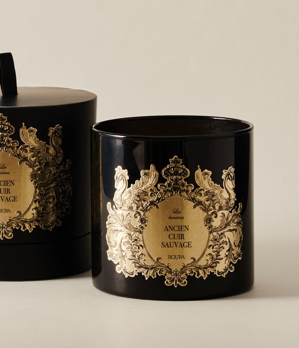 Black and gold decorative candle jar from the Ancien Cuir Sauvage collection, shown with matching gift box.