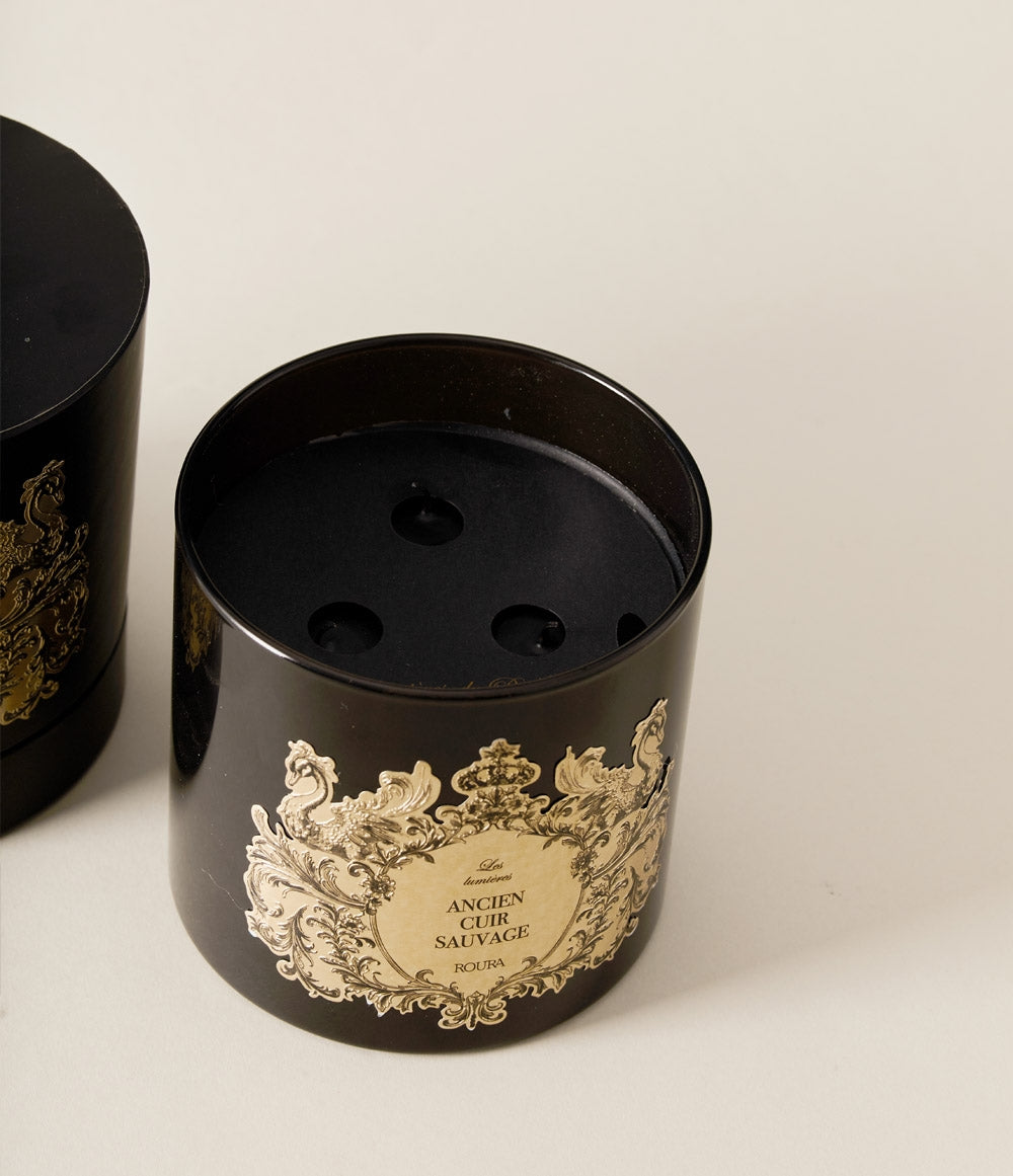 Large Ancien Cuir Sauvage candle with ornate gold label, displayed without the lid.
