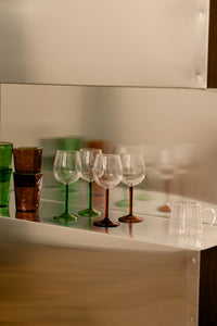 Annabelle wine glasses by Olsson & Jensen with coloured glassware on a mirrored shelf