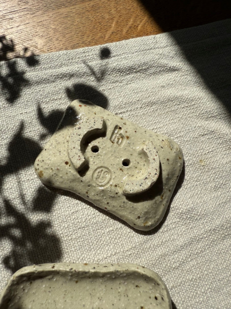Rustic rectangular ceramic soap holder with raised base and drainage holes