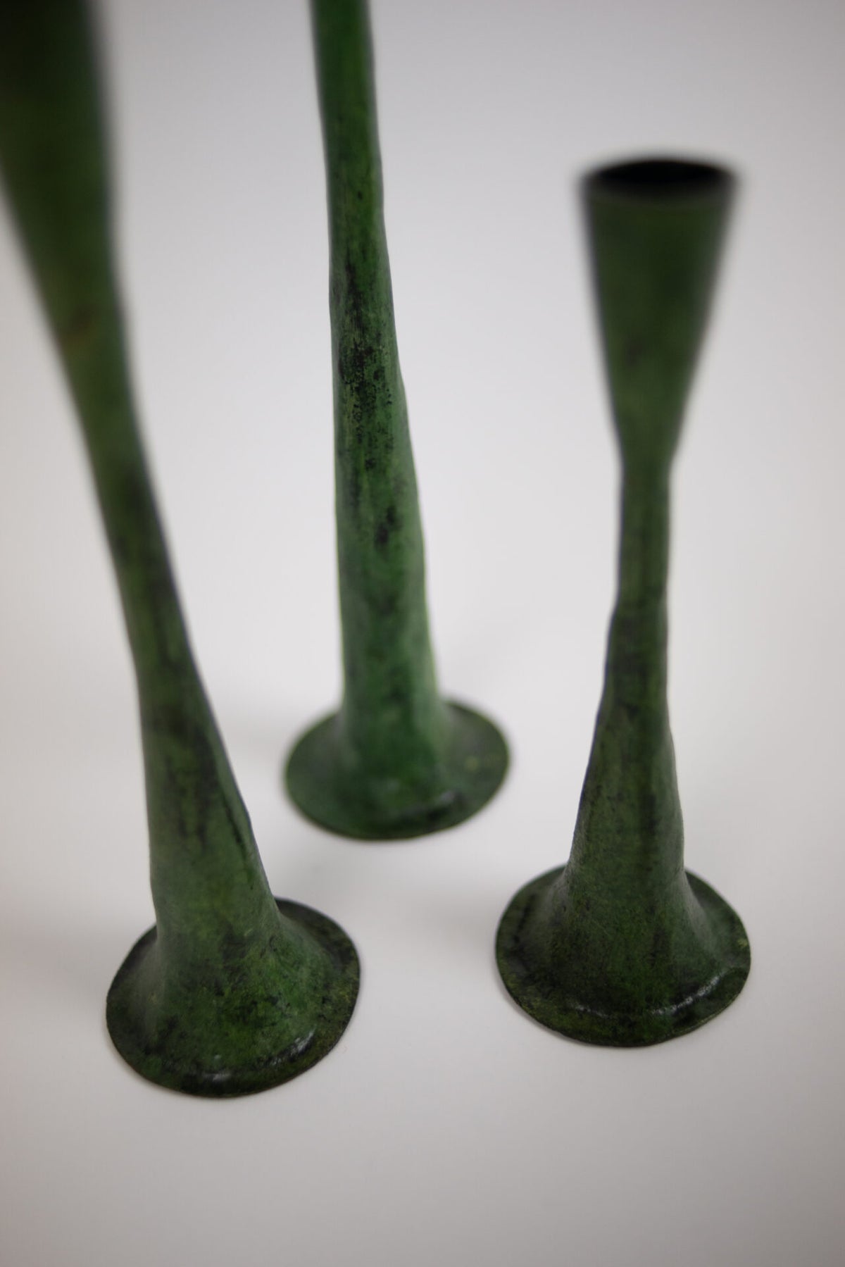Close-up of the flared bases of the Ashraf green candlesticks by Olsson & Jensen