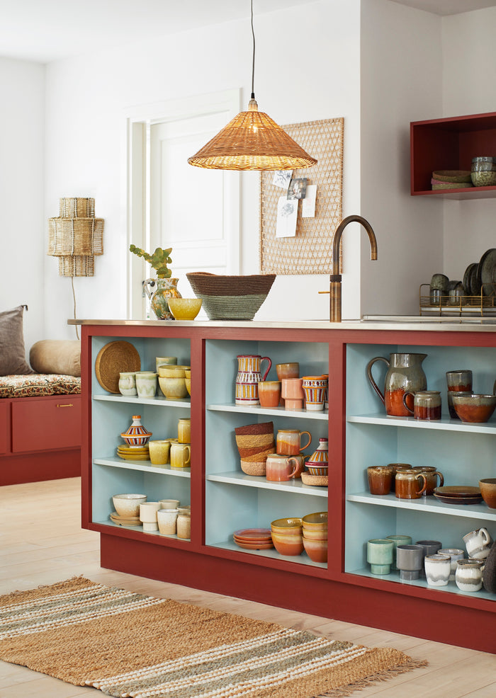 green and grey stoneware cups displayed on a contemporary kitchen shelf for minimalist style
