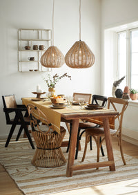 brown stoneware mugs arranged on a cosy dining table with matching crockery

