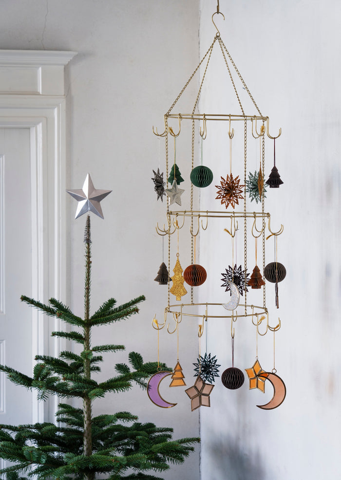 steel Christmas tree topper star styled on a natural fir tree
