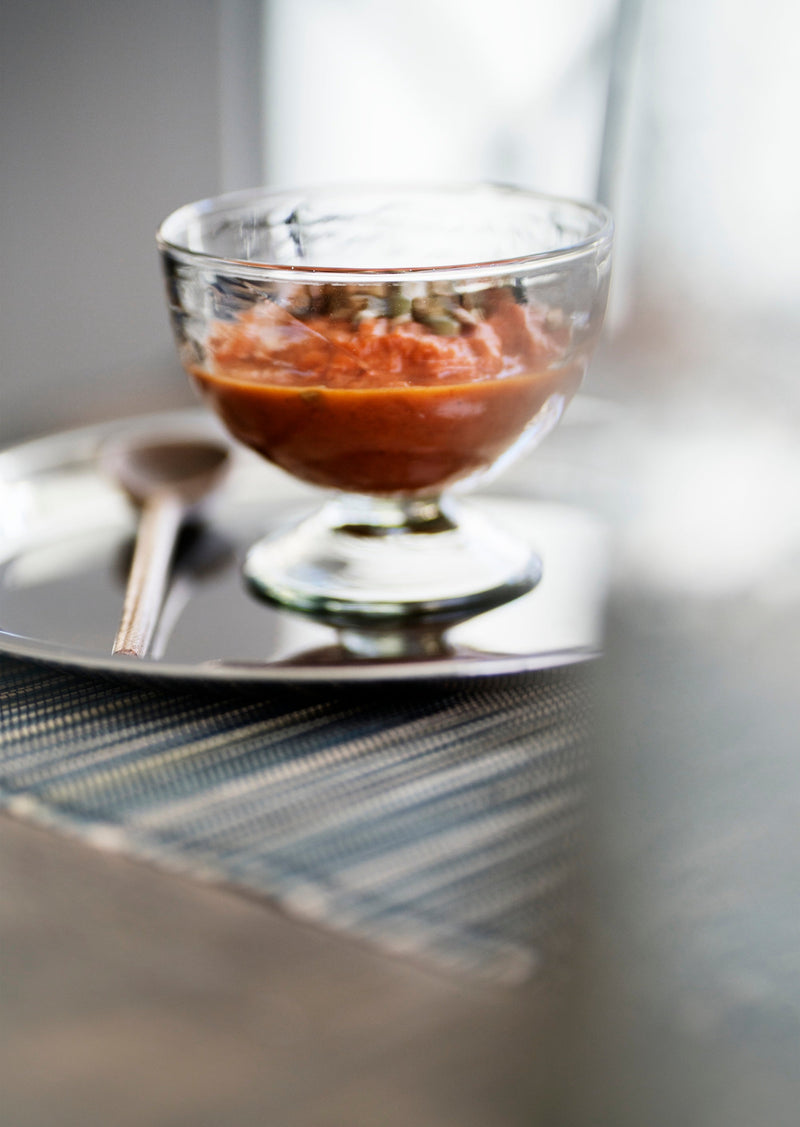 clear hammered glass ice cup holding dessert on a plate
