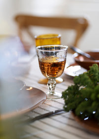 hand finished cut glass wine glass catching light on the table
