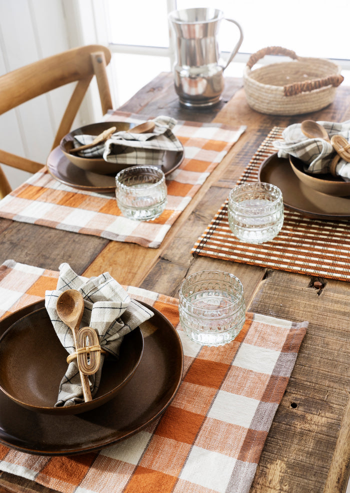 pumpkin spice bamboo placemat styled on rustic wooden dining table

