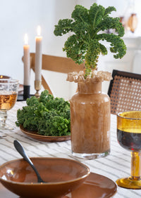 group of colourful ruffle-edge glass vases showing shape and design details
