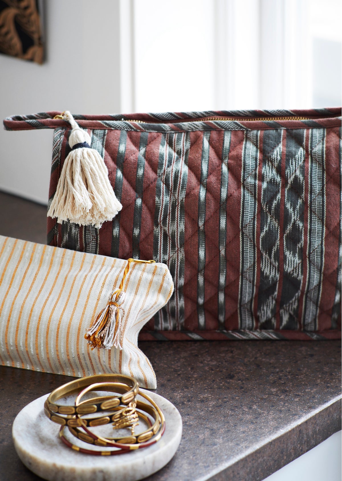 neutral beige and green marble trays styled together on rustic tabletop
