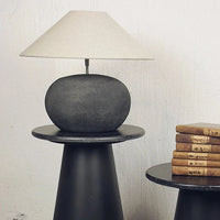 Bellac lamp base by Olsson & Jensen styled with a cream shade on a dark side table
