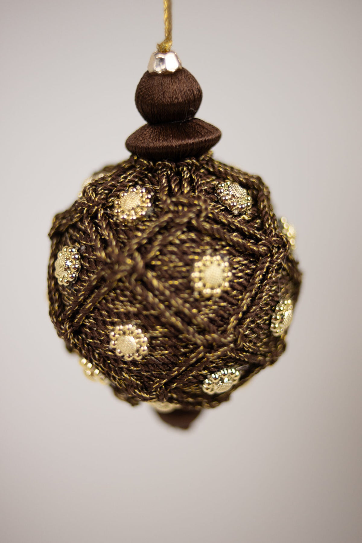 Close-up of the woven thread and gold studs on the Bellagio bauble by Olsson & Jensen