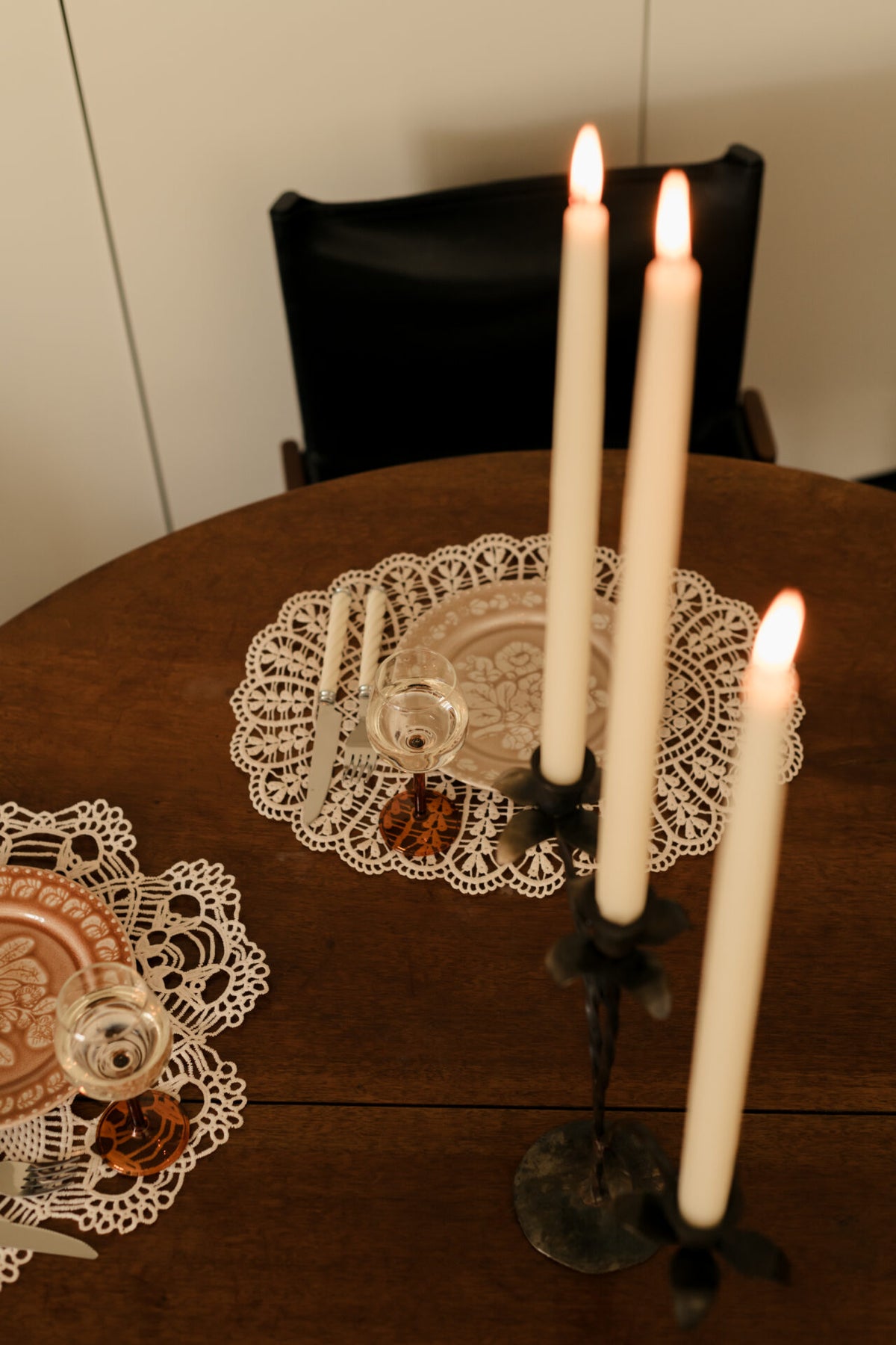 Lit Bellora candelabra by Olsson & Jensen on a round wooden table