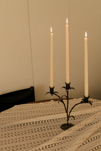 Bellora candelabra by Olsson & Jensen with taper candles on a lace tablecloth