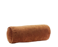 burnt orange velvet bolster cushion by Bloomingville on white background
