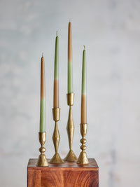 artisan green tone dip dye burma candles displayed on mixed brass candle holders