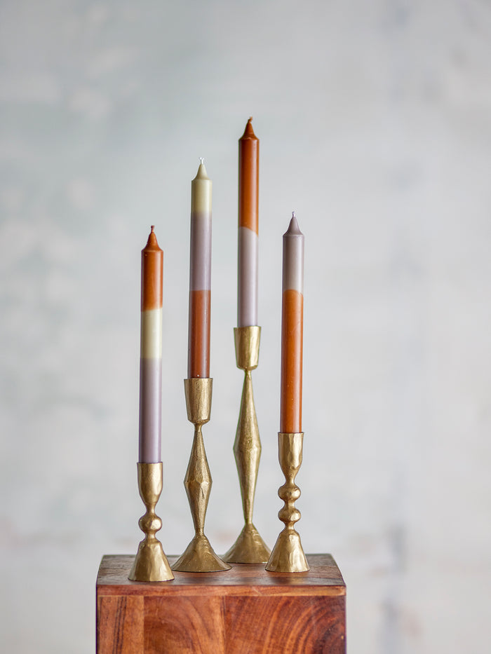 set of dip dye taper candles in brass candle holders showing purple and brown tones
