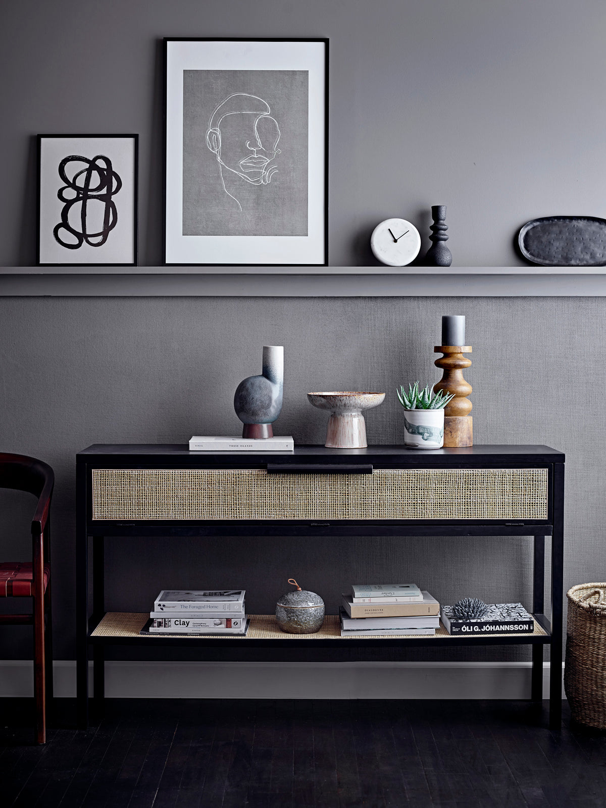 black stoneware candle holder styled on modern grey console with Nordic decor