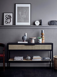 black stoneware candle holder styled on modern grey console with Nordic decor