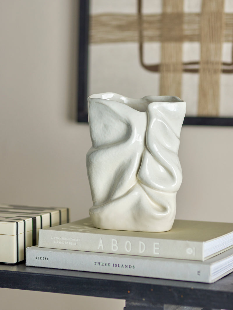 sculptural white bloomingville fabrice vase styled on books in a modern neutral living space