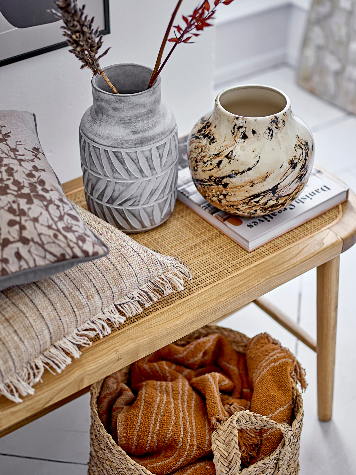 warm brown ginna recycled cotton throw by bloomingville styled on bench in cosy nordic living space
