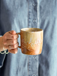 hand holding bloomingville milani mug showing reactive glaze details
