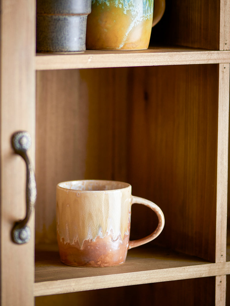 rustic stoneware milani mug in natural reactive glaze on wooden shelf
