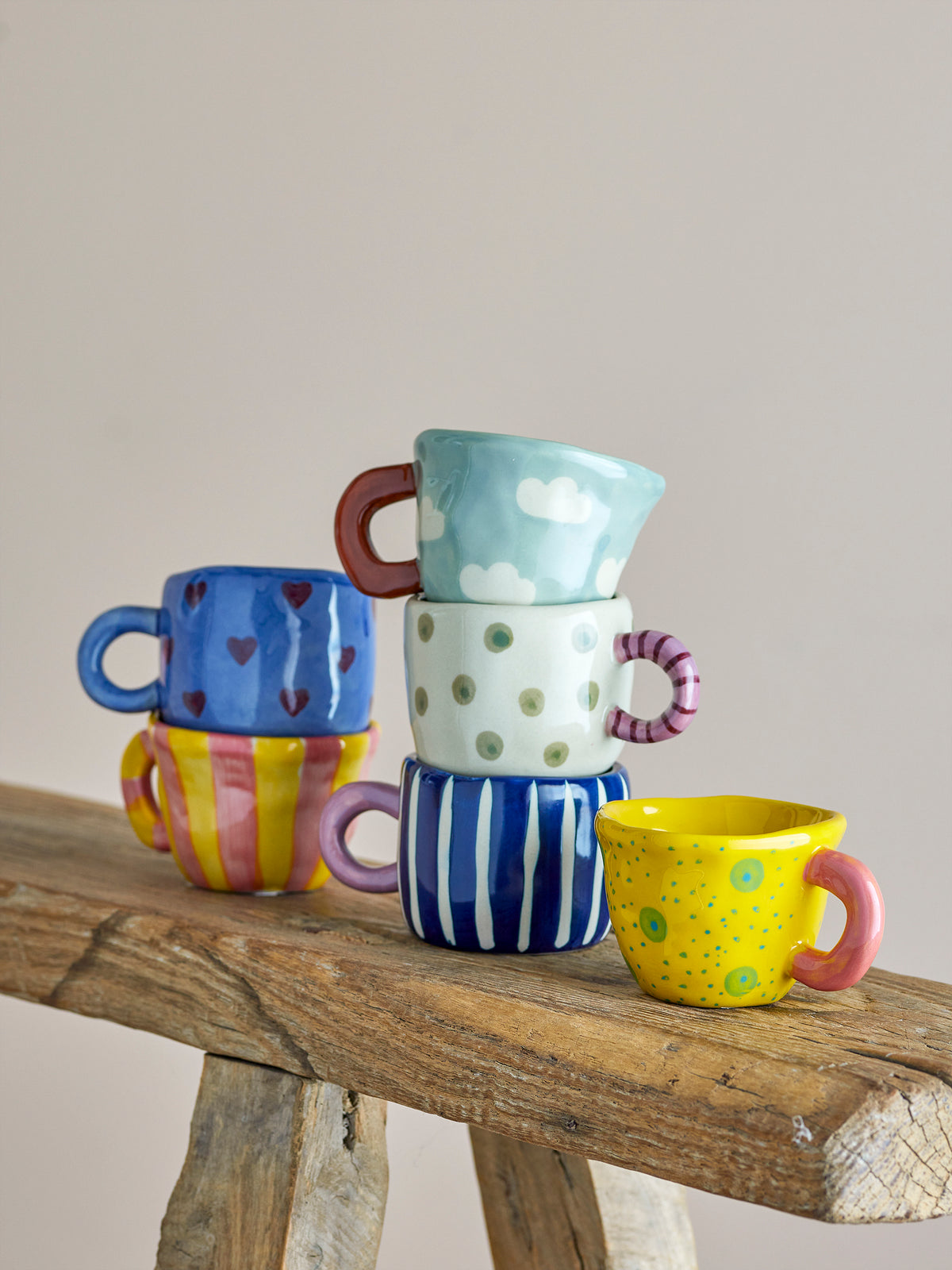 playful bloomingville nini cups stacked on rustic wood including blue heart design