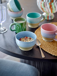 colourful stoneware mugs including green Bloomingville ninka mug on a breakfast table for cosy mornings