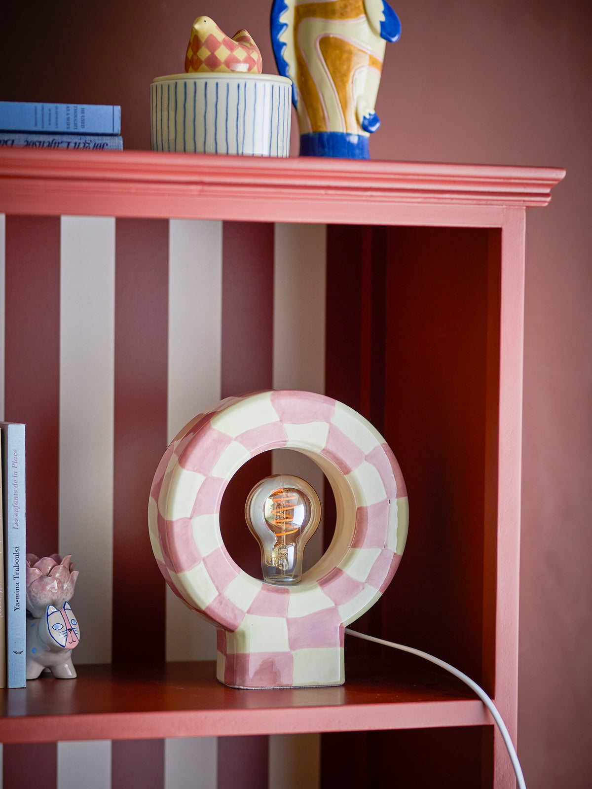 rose and yellow checker bloomimgville vialini table lamp styled on shelf
