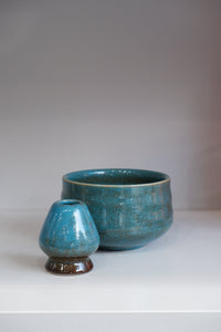 handmade blue ceramic matcha bowl with crackle glaze and green undertones
