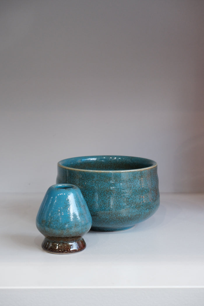 handmade blue ceramic matcha bowl with crackle glaze and green undertones

