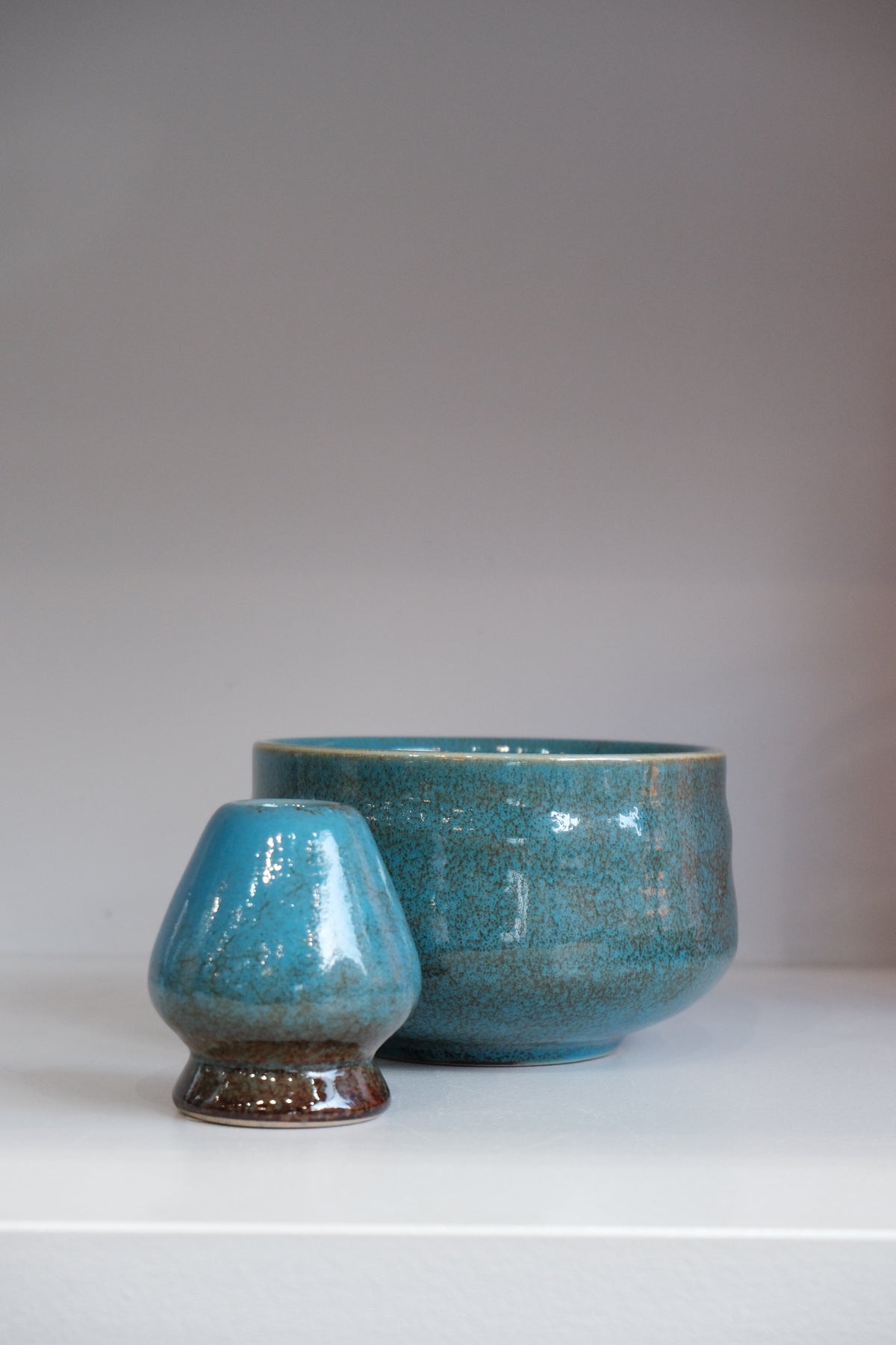 blue ceramic matcha whisk holder with crackle glaze detail
