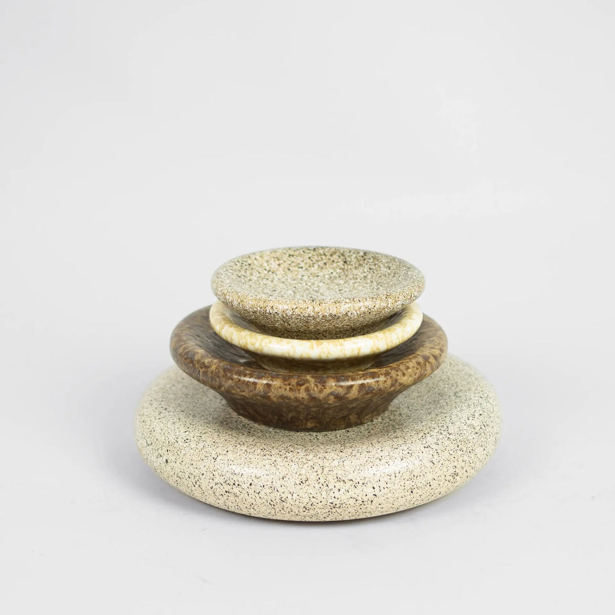 Stack of Boel speckled stoneware plates and bowls by Olsson & Jensen in mixed colours