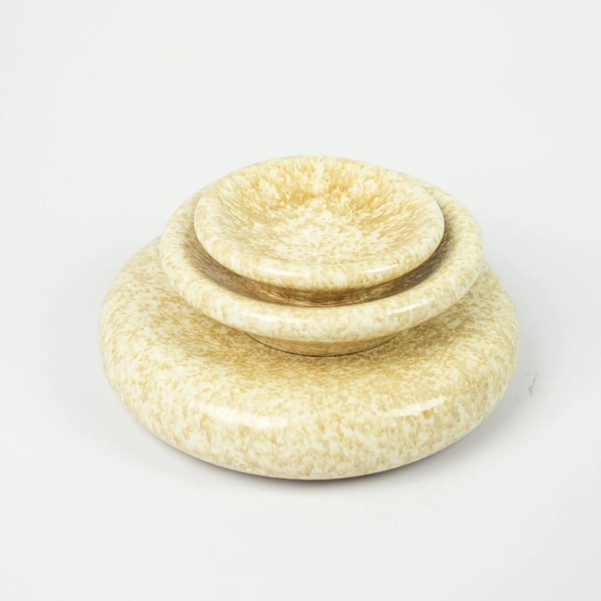 Stack of Boel yellow speckled stoneware pieces by Olsson & Jensen