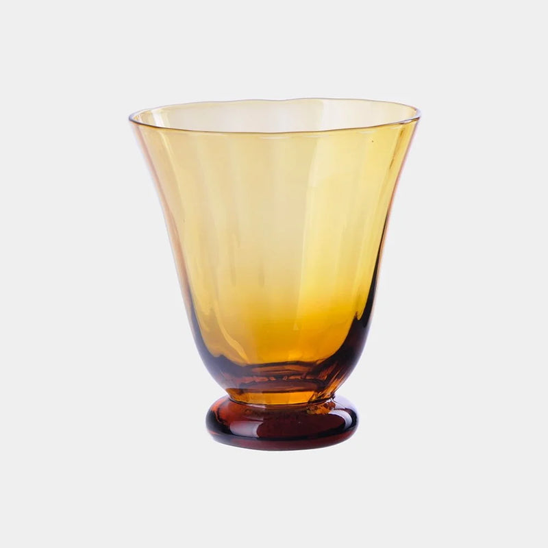 Boule amber fluted glass on a short foot by Olsson & Jensen on a white background