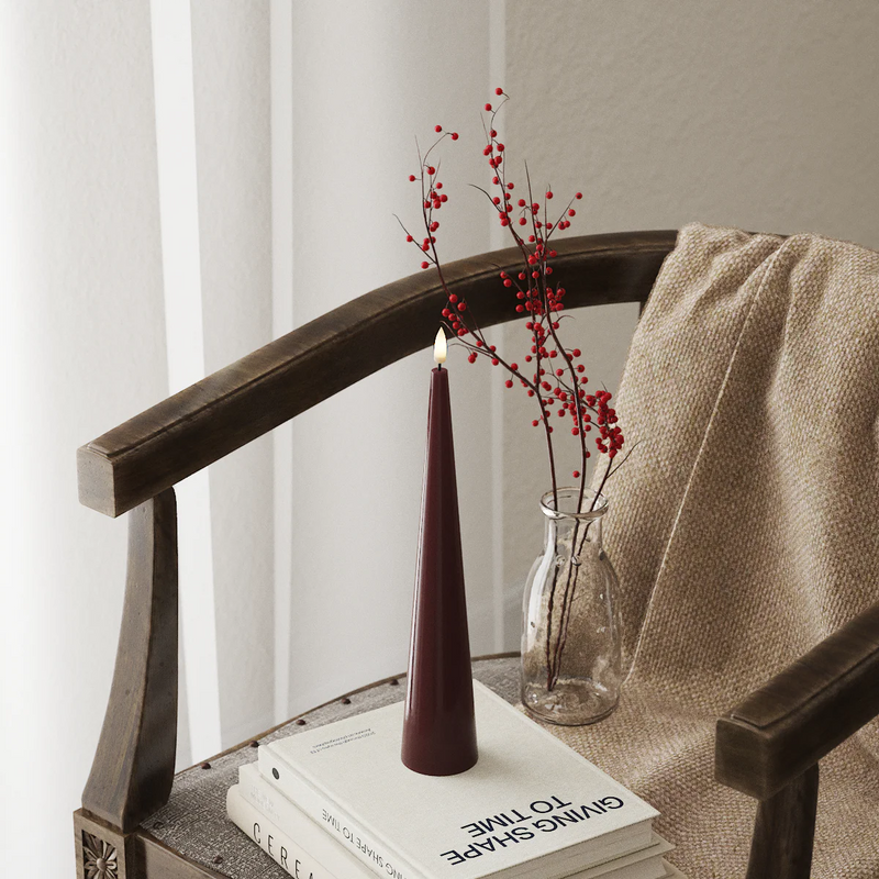 bourgogne red cone led candle styled on books with soft cosy decor