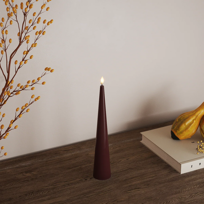 deep red cone led candle on wooden tabletop creating warm cosy lighting