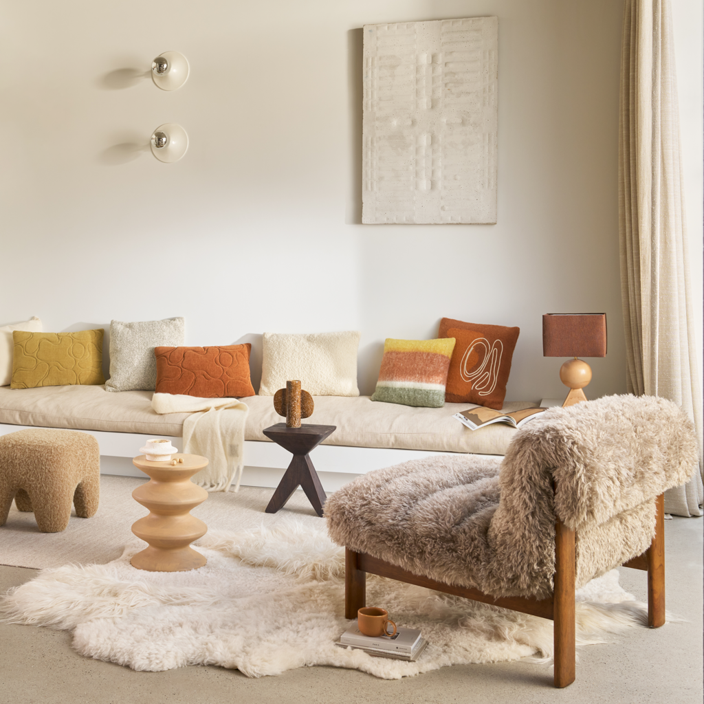 Urban Nature Culture pieces styled in a neutral living room with a sheepskin armchair
