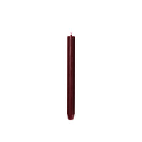 Broste Copenhagen Rustic Taper Candle in burgundy on a white background