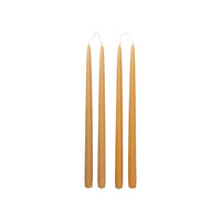 Four Broste Copenhagen Smooth Taper Candles in matt golden yellow on a white background
