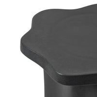 Close-up of the Sonja Pedestal Tall showing the matt black reactive glaze and wavy edge