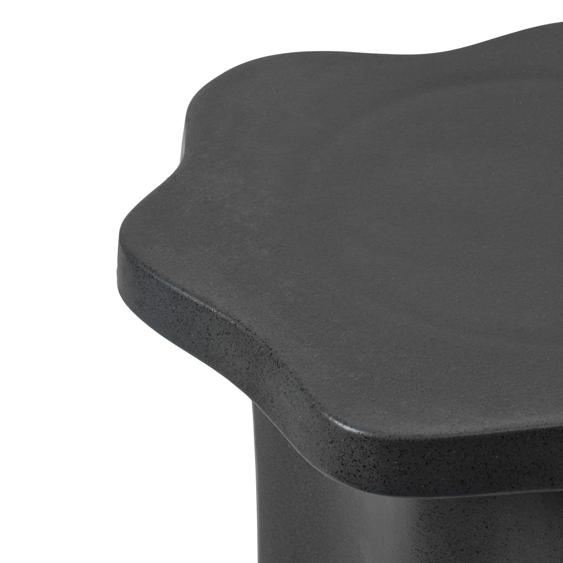 Close-up of the Sonja Pedestal Tall showing the matt black reactive glaze and wavy edge