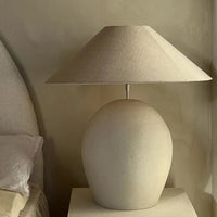 Calais lamp base by Olsson & Jensen with a linen shade styled in a calm bedroom
