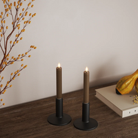 Pair of caramel brown LED dinner candles styled in a warm autumn home scene