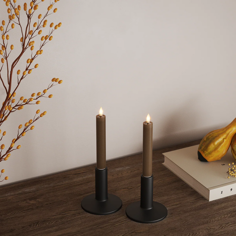 Pair of caramel brown LED dinner candles styled in a warm autumn home scene