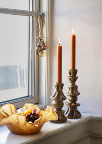 caramel glass ruffle bowl styled on windowsill with candles for warm home decor
